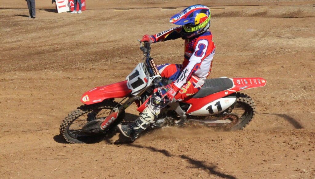 A motocross rider maintains good stability in a turn