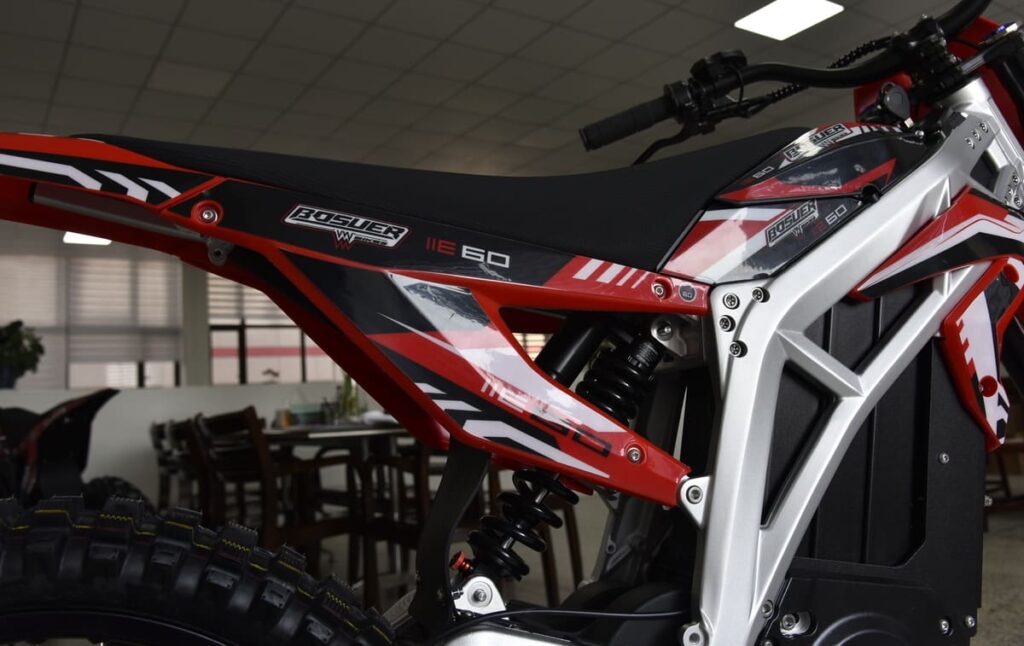 electric dirt bike frame stored in a garage