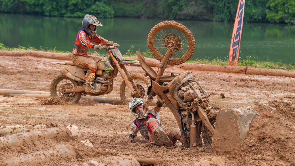 motorcross track with obstacles and riders falling on it